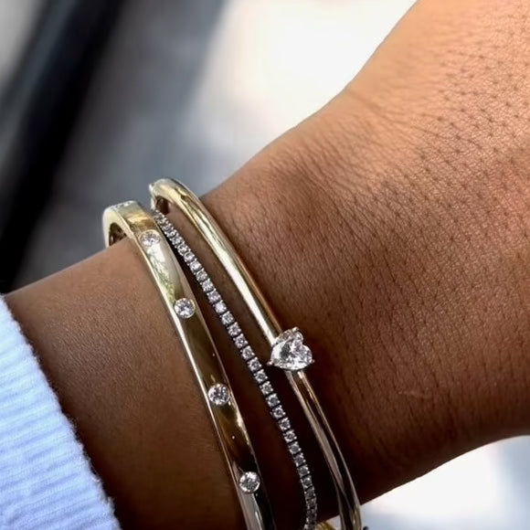 HEART SHAPED DIAMOND SET ON A GOLD DOMED BANGLE